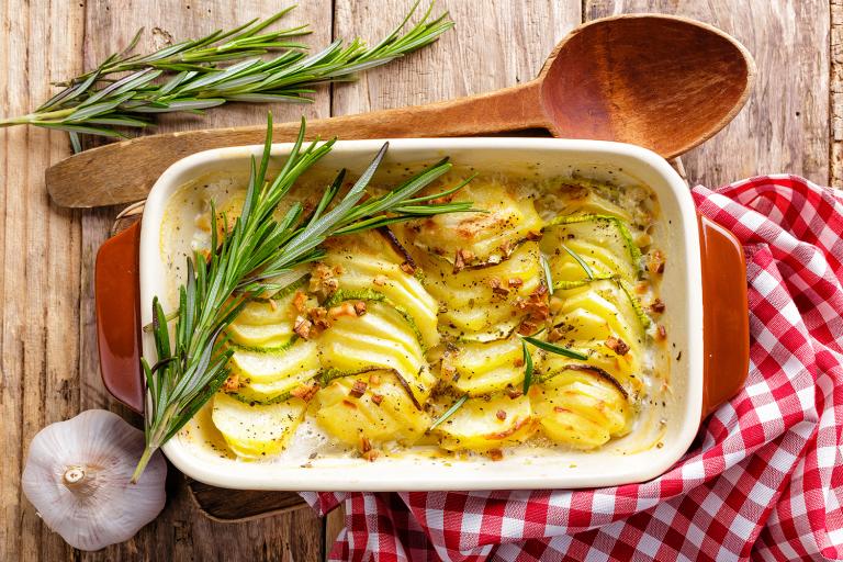 A dish of potatoes au gratin with rosemary